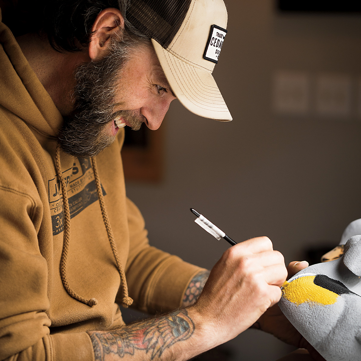 Man carving decoy. Photo by cedarrundecoys.com.