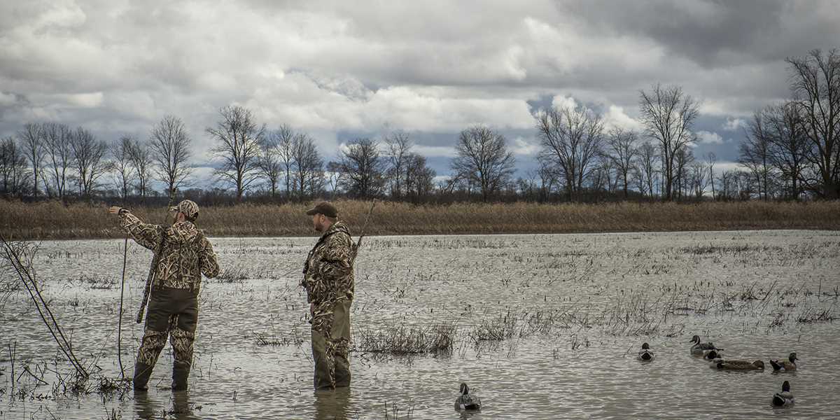 Waterfowl hunters in wetland. Photo by BillKonway.com