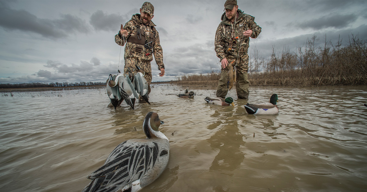 Waterfowl hunters placing decoys. Photo by BillKonway.com